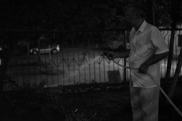 Hussien watering plants at night