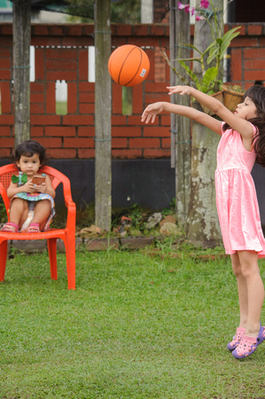 Nur Eryna and Qamelia playing basketball in garden