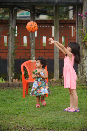 Nur Eryna and Qamelia playing basketball in garden